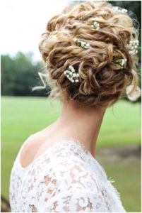 Naturally curl messy updo with flowers