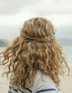 Naturally curly half up braided hairstyle