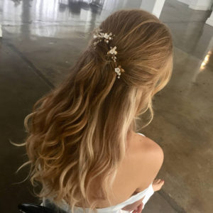 Half up hairstyle with floral hair pins- 2018 wedding hair trends