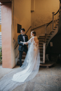 Bride Ali Wears The Draped In Flowers Cape 2.jpg