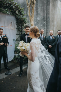 Bride Ali Wears The Draped In Flowers Cape 4.jpg